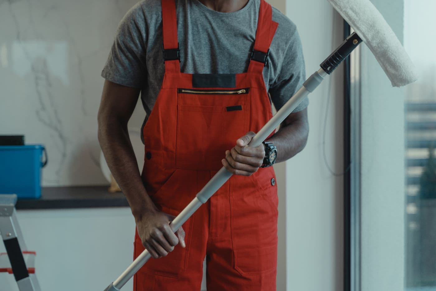 PrimeClean Commercial crew member cleaning glass in a modern commercial office building